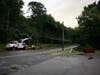 Trees were knocked down by a storm on July 12 causing damage to a sign and building at the Hood Plant on North State Street. 