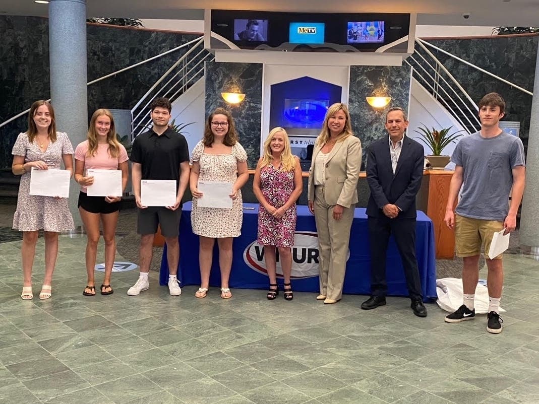 Members of the NHAB Board of Directors gather with scholarship recipients.