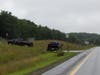 New Hampshire State Police and New Hampshire Fish & Game officers are searching a stretch of highway between Exits 17 and 20 on Aug. 10, for evidence in the Sweeney family triple homicide. 