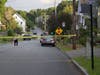 A New Hampshire State Police investigator takes a picture of a bullet casing found in the middle of Rumford Street after a shooting on Aug. 20. 