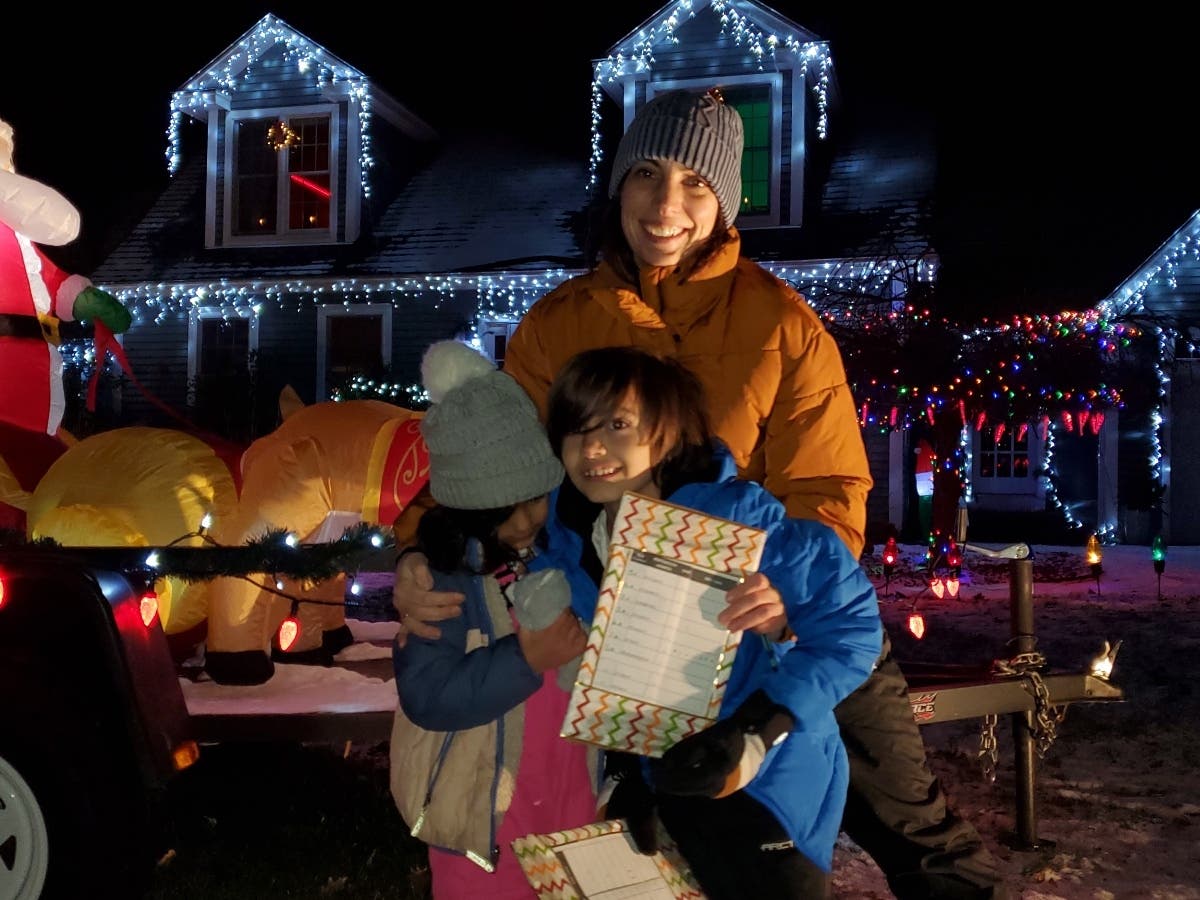 Citywide Neighborhood Committee contest judges included Tracy Kittle and her two children, Elliott and Isobel, shown here while judging one of the honorable mention winners' displays.