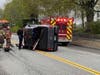 Concord fire and rescue teams assist in removing a driver after a pickup truck rolled on Franklin Street on May 3.