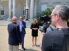 Republican presidential candidate Perry Johnson when questioned by a voter outside the Statehouse in Concord on May 11.