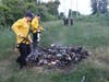 A pile of debris near a homeless camp burns on June 29 near Market Basket on the north side of Storrs Street. 