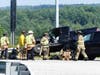 Concord police and fire and rescue teams deal with a crash on Route 106 at the Interstate 393 interchange on July 28. 