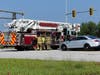 Concord police and fire and rescue teams deal with a crash on Route 106 at the Interstate 393 interchange on July 28. 