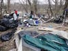 A hazmat team, possibly hired by the state of New Hampshire, has been cleaning up a massive homeless camp off Sexton Avenue for days.