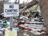 A hazmat team, possibly hired by the state of New Hampshire, has been cleaning up a massive homeless camp off Sexton Avenue for days.