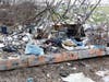 A hazmat team, possibly hired by the state of New Hampshire, has been cleaning up a massive homeless camp off Sexton Avenue for days.