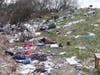 A hazmat team, possibly hired by the state of New Hampshire, has been cleaning up a massive homeless camp off Sexton Avenue for days.