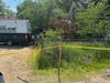 Concord police and a general services employee were seen excavating property on Airport Road, the site of a former drug den, on May 31.