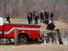 The scene at the Bow boat ramp on March 20, after firefighters searched the Merrimack River for a man who jumped from the Manchester Street bridge. A Concord detective inspects an item found in the river, believed to be the jumper's backpack. 