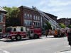 Smoke from the roof of a Downtown Concord building closed North Main Street temporarily on May 28.