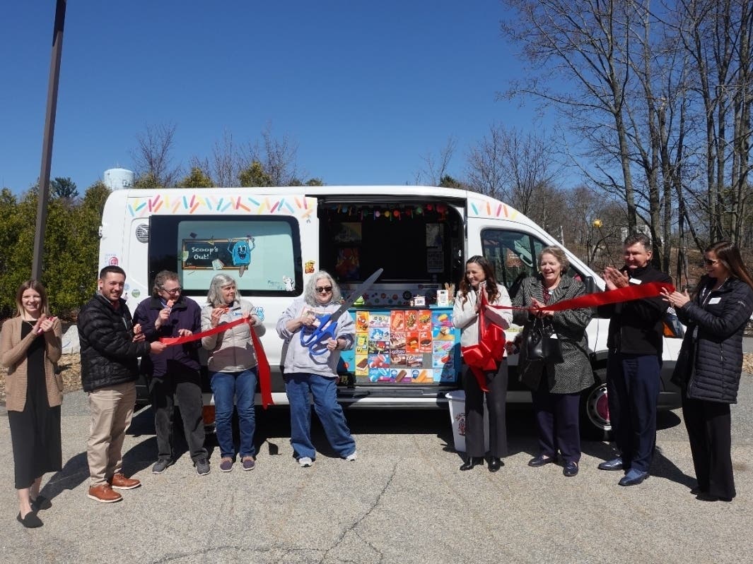 Lisa Morris, owner of Scoop’s Out! LLC, surrounded by Chamber members and friends.