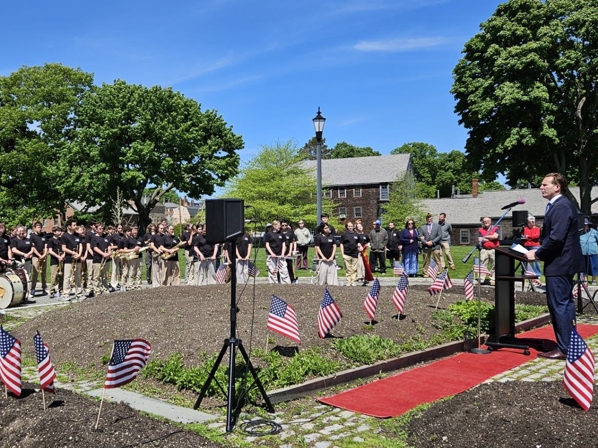 Mayor Deaglan McEachern offers remarks at the memorial ceremony for those lost at sea, along with the Portsmouth Middle School 7th & 8th Grade Band under the direction of Courtney Randall.