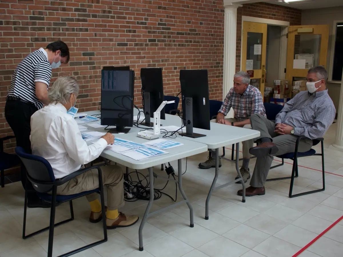 David Croft, pictured center-right in this 2020 file photo, views ballots during a recount in Concord, which led to his winning the Democratic primary by 220 votes out of about 17,000 cast.