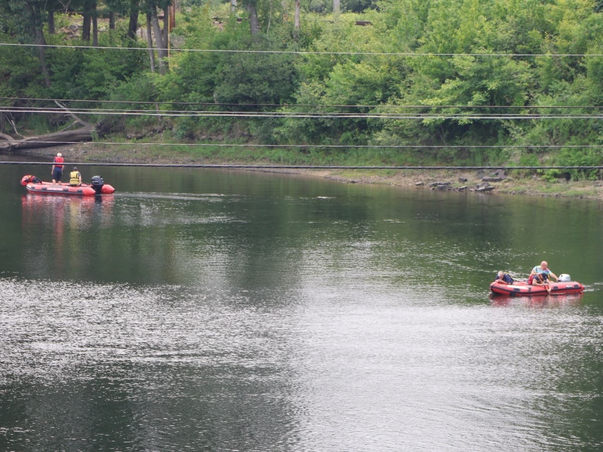 Boscawen and Concord firefighters, manned on boats, attempt to find a drowning victim on July 15.