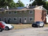 Two Concord police officers guard the entrance of an apartment at Building 8 at the Royal Gardens apartment complex on Sept. 10.