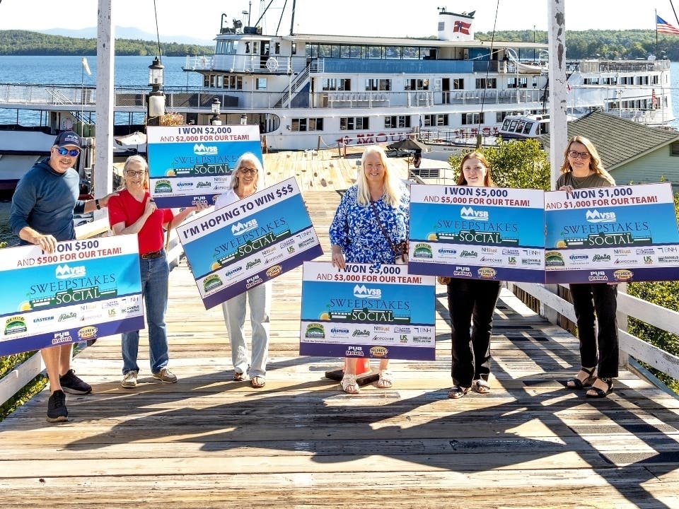 From left, Pub Mania members Allan Beetle, Judi Taggart, and Jennifer Beetle stand with MVSB's Sue Dagostino, Mariah Reever, and Becky Reposa in front of the M/S Mount Washington in Laconia.