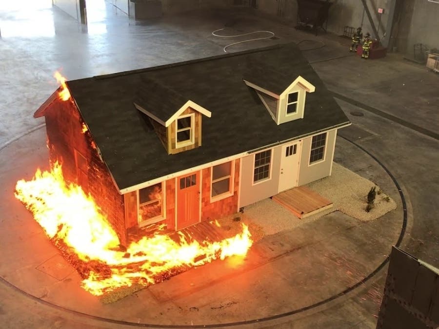 ​The right side of this tabletop model house was built with fire-resistant materials, unlike the left side.