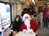 Novato Police Chief Matthew McCaffrey and Khris McCaffrey share a ride with Santa on the first SMART train to the new Novato Station.  