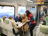 Passengers take the first SMART train on Saturday from Santa Rosa to Larkspur. 