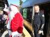 Santa, along with Novato Police Chief Matthew McCaffrey​​, climb aboard SMART's Holiday Express Toy Drive Train.​
