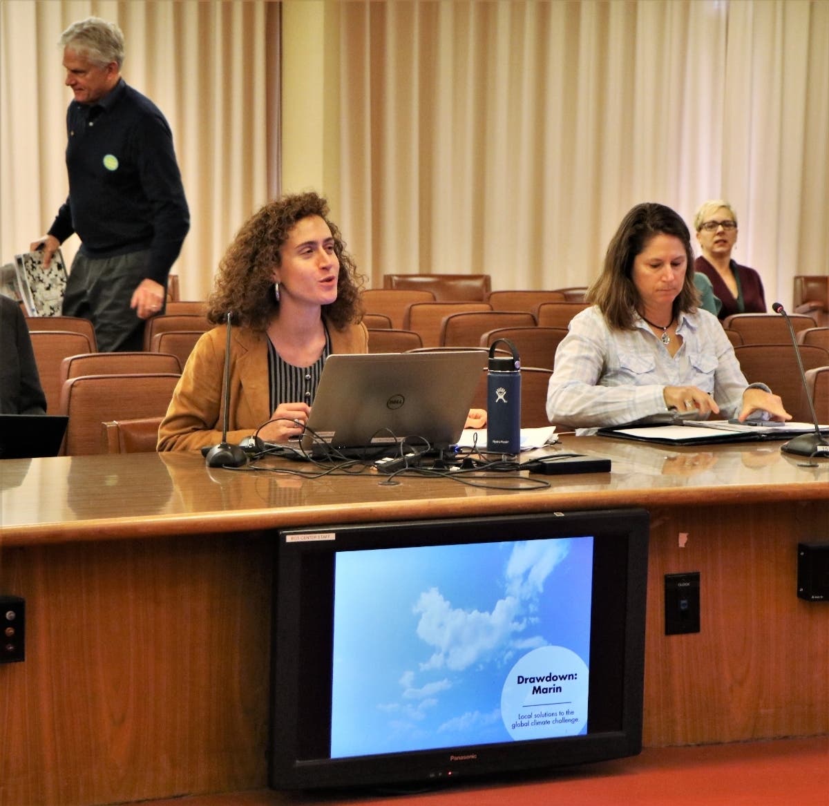 Alex Porteshawver (left, seated), sustainability senior program coordinator, gives a presentation on Drawdown: Marin to the Board of Supervisors on Dec. 17, 2019.