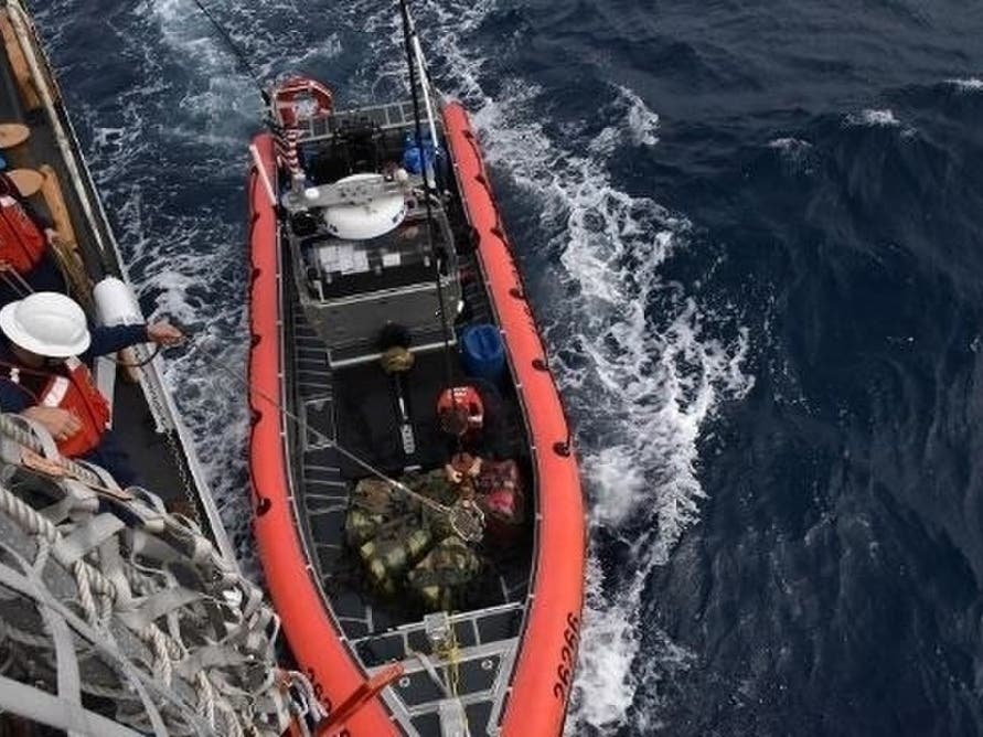 Coast Guard Cutter Thetis (WMEC 910) crew members hoist interdicted drugs seized in international waters of the Eastern Pacific Ocean Nov. 16, 2019. Coast Guard crews seized nearly 20,000 pounds of cocaine worth an estimated $338 million.