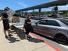 Novato High School seniors picked up their signs while driving through the school parking lot.