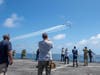 Sailors and civilian mariners aboard the hospital ship USNS Mercy (T-AH 19) watch the U.S. Air Force Air Demonstration Squadron, “Thunderbirds," fly over Mercy during a transit to San Diego.