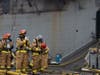 Sailors and Federal San Diego Firefighters equip gear before providing firefighting assistance on board USS Bonhomme Richard (LHD 6) on the morning of July 13.