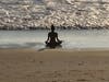 A woman doing yoga on the beach in Oceanside, California.