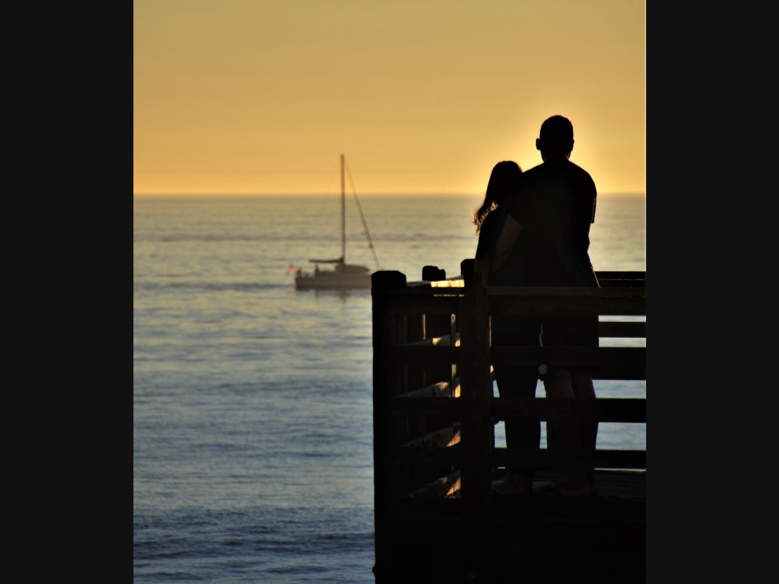 A couple enjoying the sunset in Oceanside, California 