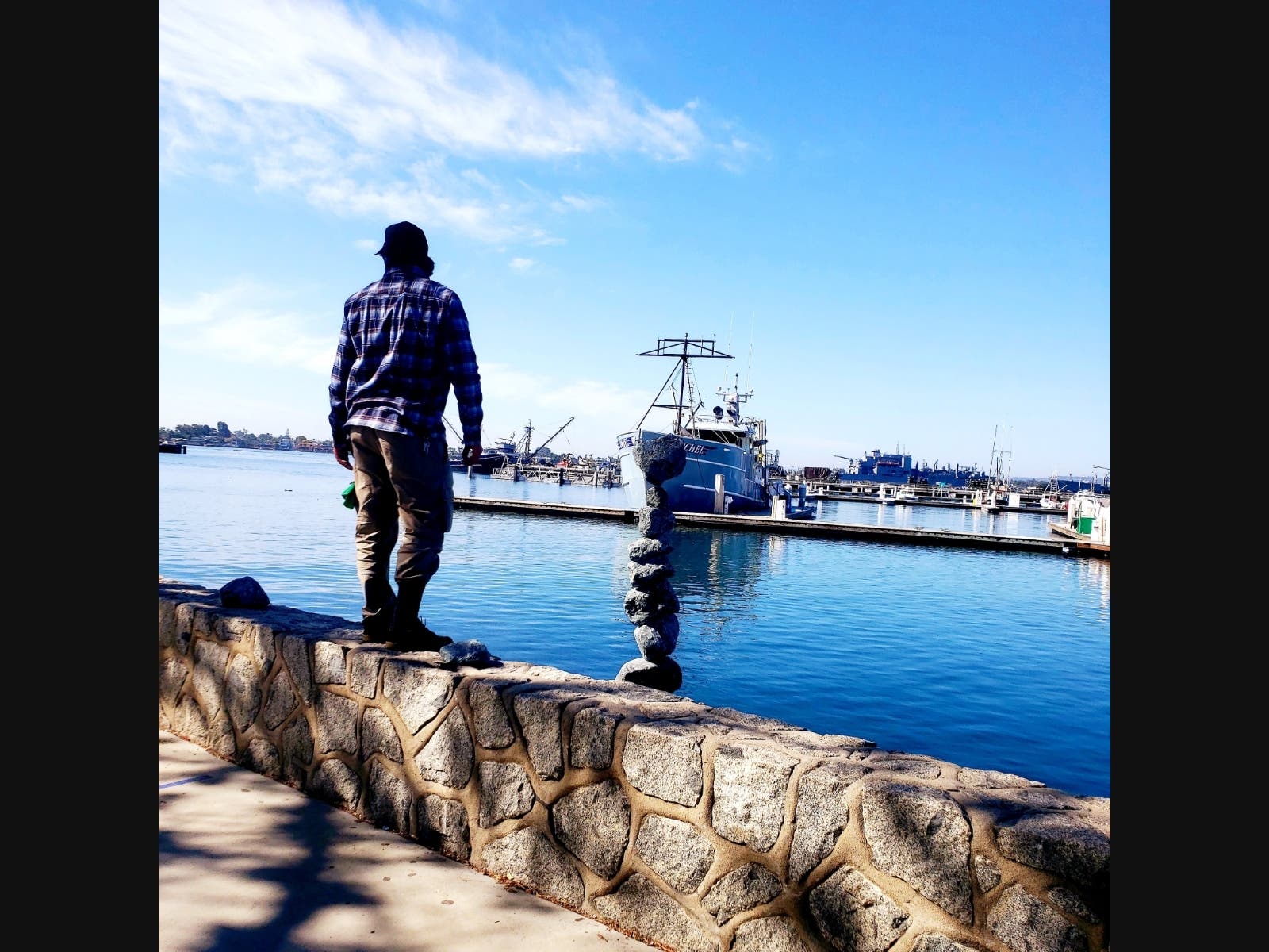 A man with a rock tower in San Diego, California