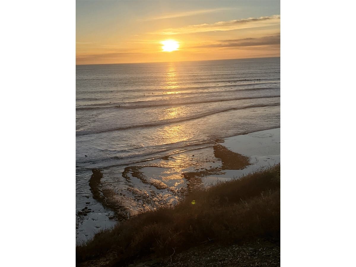 The sun sets over Swami's Beach in Encinitas, California. 