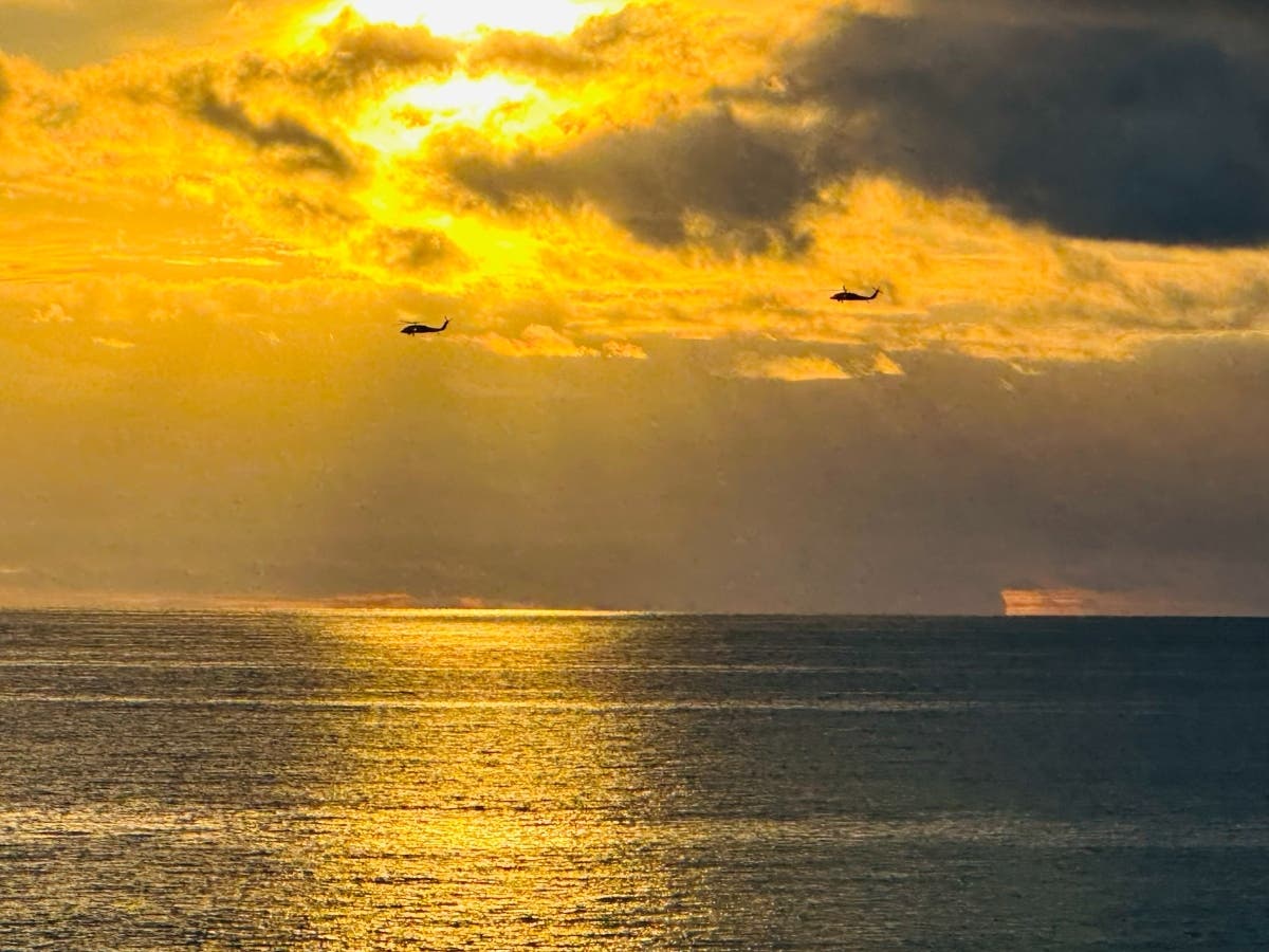 Helicopters fly over South Carlsbad State Beach.