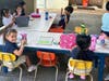 School children return to the school which burned down in Lahaina earlier this summer.