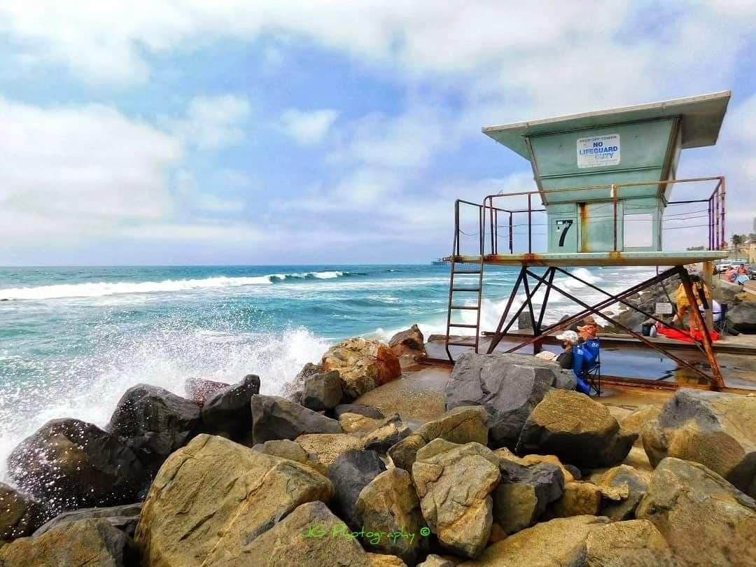 Beachgoers watching the waves in Oceanside, California.
