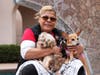San Diego resident Patricia reunites with her three dogs. 