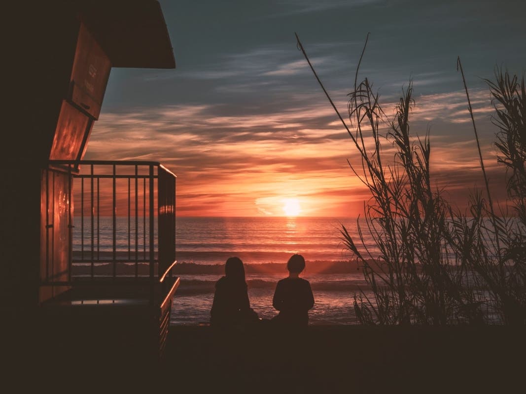 People enjoying the sunset at Carlsbad State Beach.