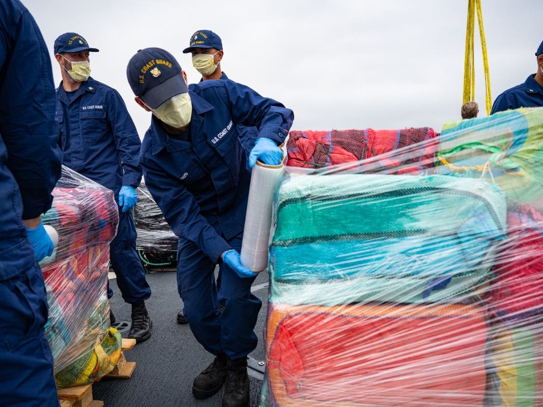Crew members from the U.S. Coast Guard Cutter Munro offload 33,768 pounds of cocaine, in San Diego.