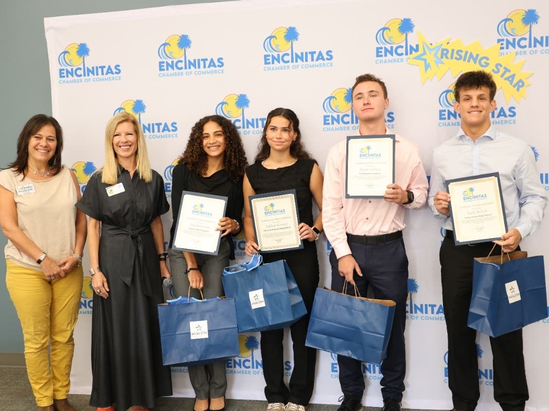 L-R: Board Member Roueida Hobeika Matin and Encinitas Chamber CEO Carol Knight with Leilah Crosby of Canyon Crest Academy; Caelan Kenney of La Costa Canyon High School; Jason Gallant of San Dieguito Academy; and Zach Bulich of Torrey Pines High School.