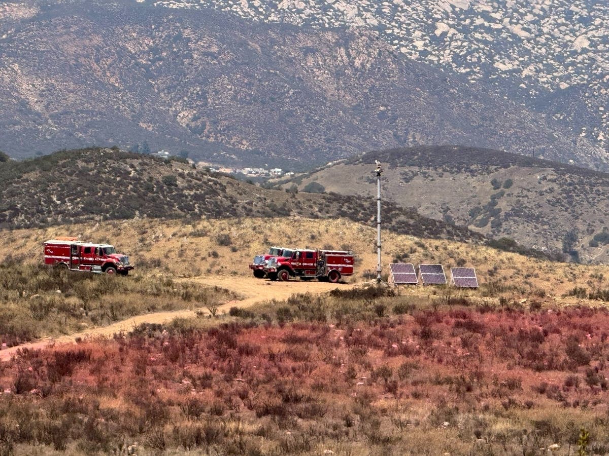 The Border 6 Fire has blackened 2,617 acres in a remote, rugged area near Tecate Peak, according to Cal Fire.