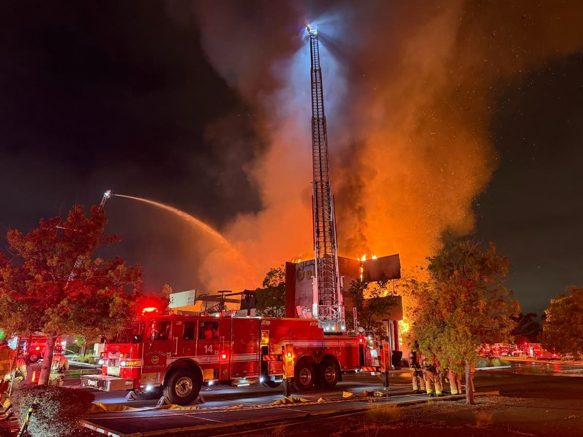 A three-alarm fire destroyed a commercial building in San Diego's Serra Mesa neighborhood, prompting a response from more than 100 firefighters.