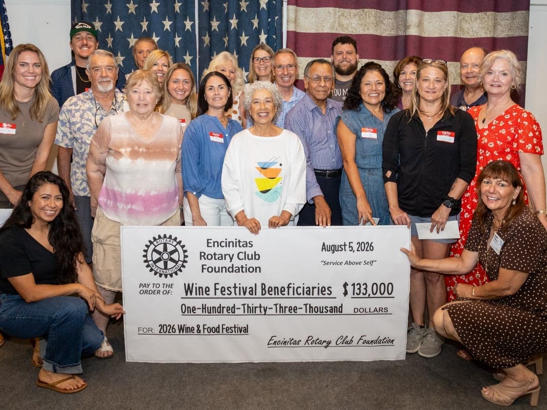 Guests representing the 2026 beneficiary organizations accept their checks at the Encinitas Elks Lodge. Event Director Gaby Reyes (left) and outgoing Event Director Sherry Yardley (right) hold the check. 