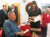 Medfield Housing Authority Chair Lisa Donovan shows Paul Hinkley the certificate on the re-naming of Tilden Village community room in his name. Looking on (l to r): Rep. Shawn Dooley, Chair of Board of Selectman Mike Marcucci, and Rep. Denise Garlick. 