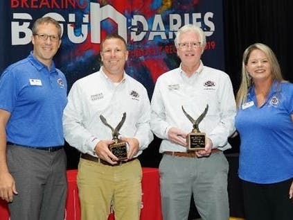 Stuart Nokes, second from right, accepts his Excellence in Mentoring award at the Neighborly International Conference.