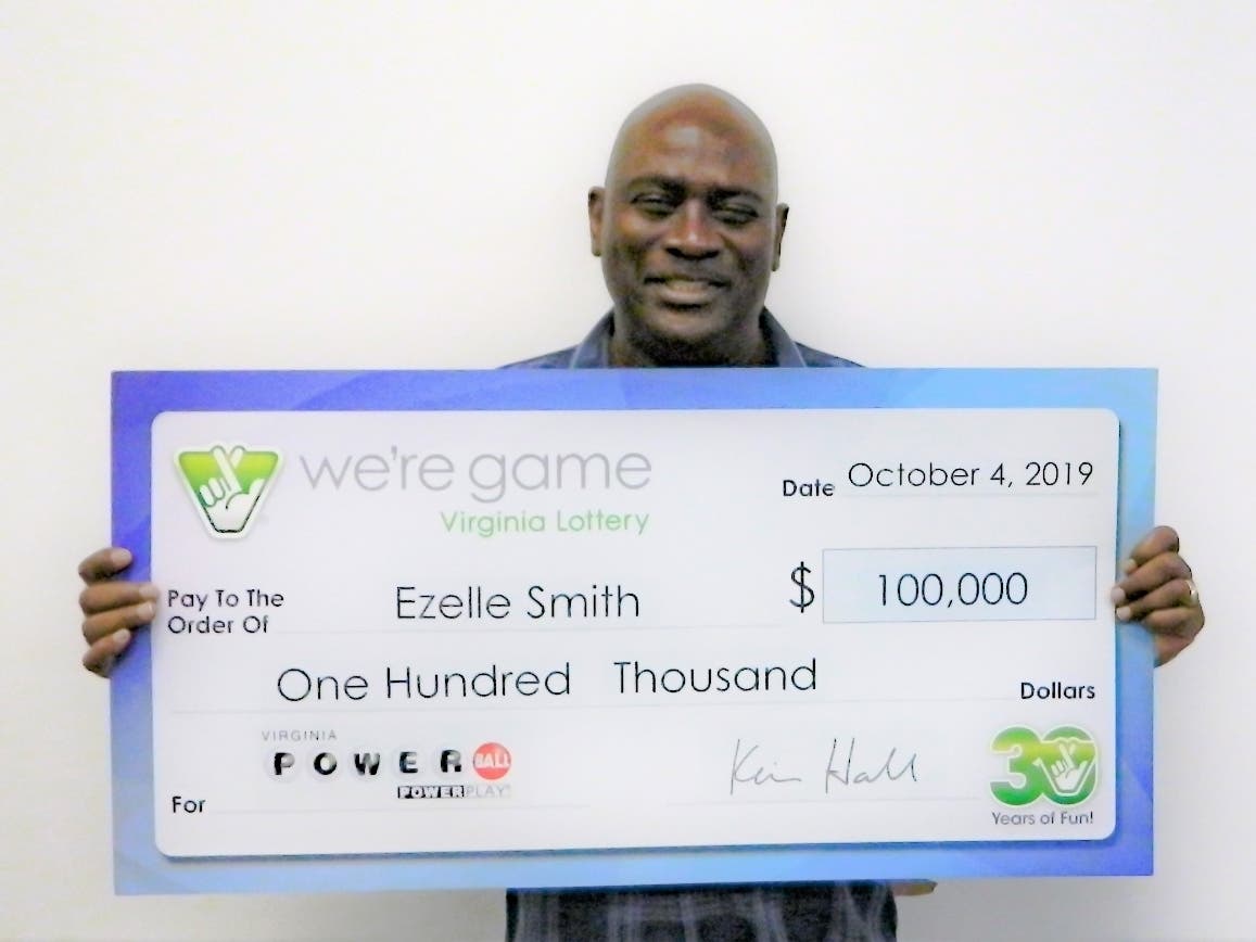 Ezelle Smith of Woodbridge proudly displays his winnings in a recent Powerball drawing.