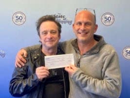 John Galvin, left, and Eric Cochrane will split a $1 million lottery prize after Galvin did a good deed Cochrane.